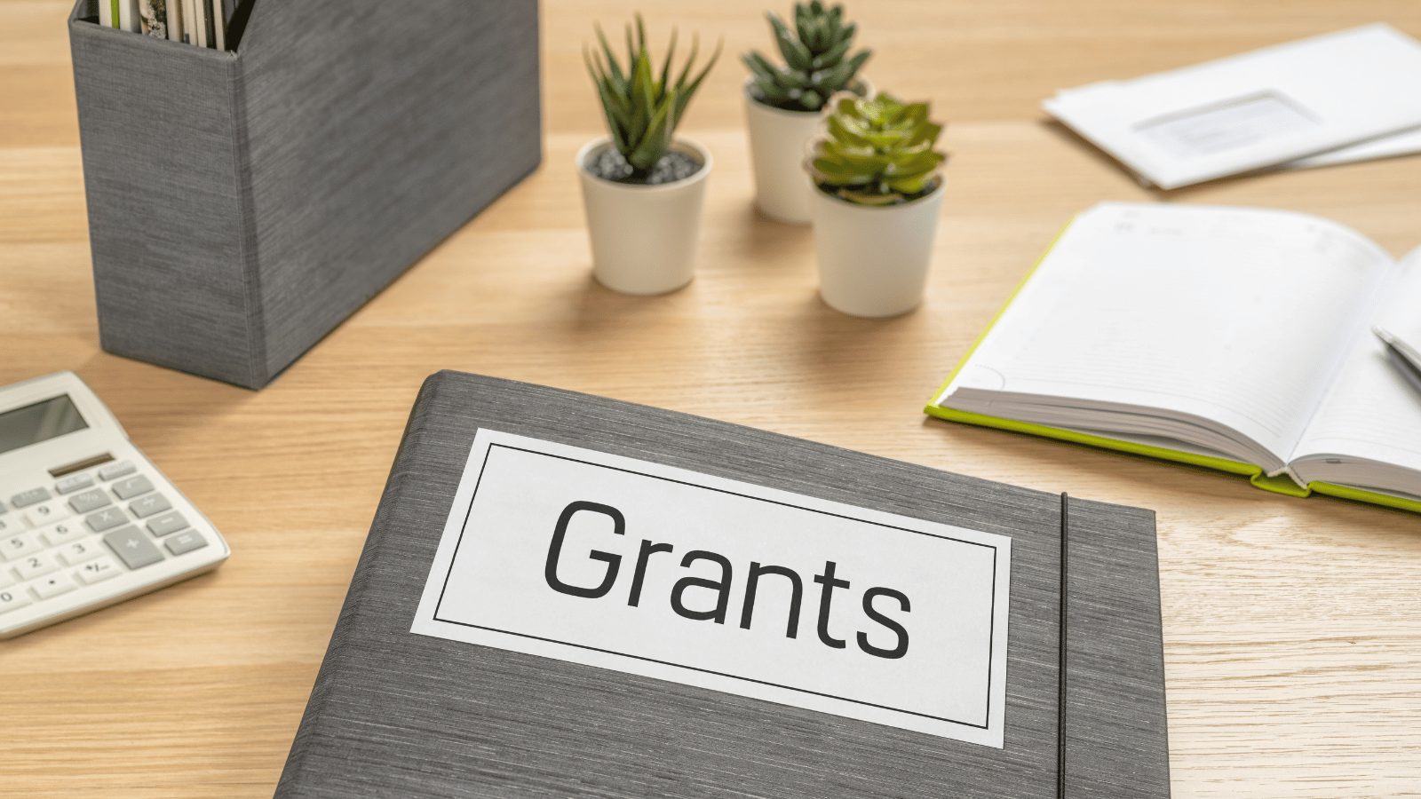 File on desk with words 'grants' in capital letters