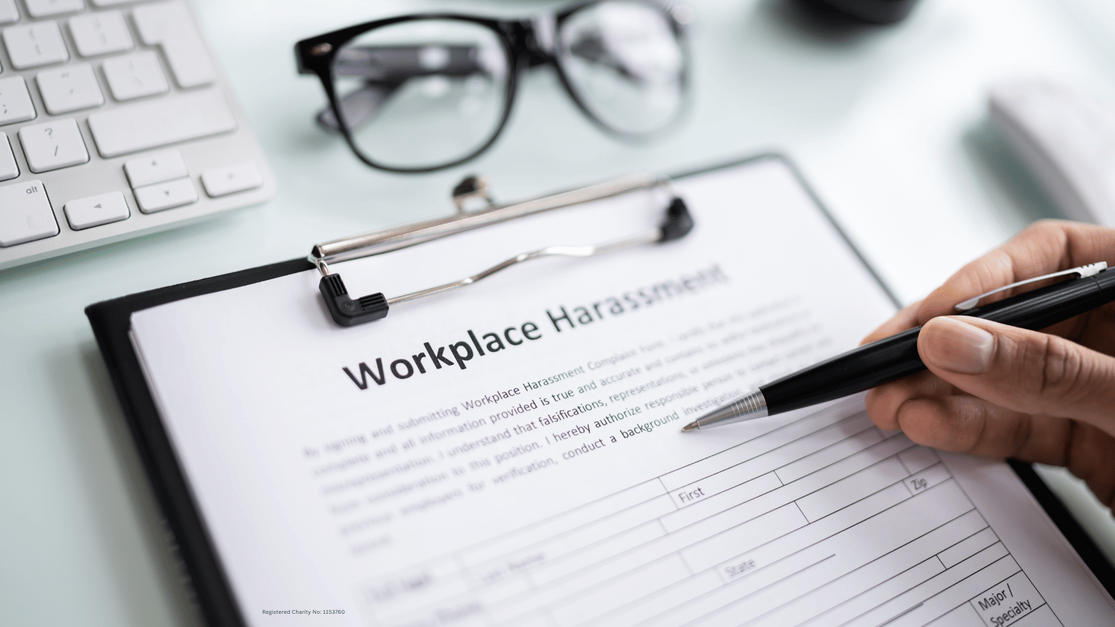 Person filling out harassment form at work