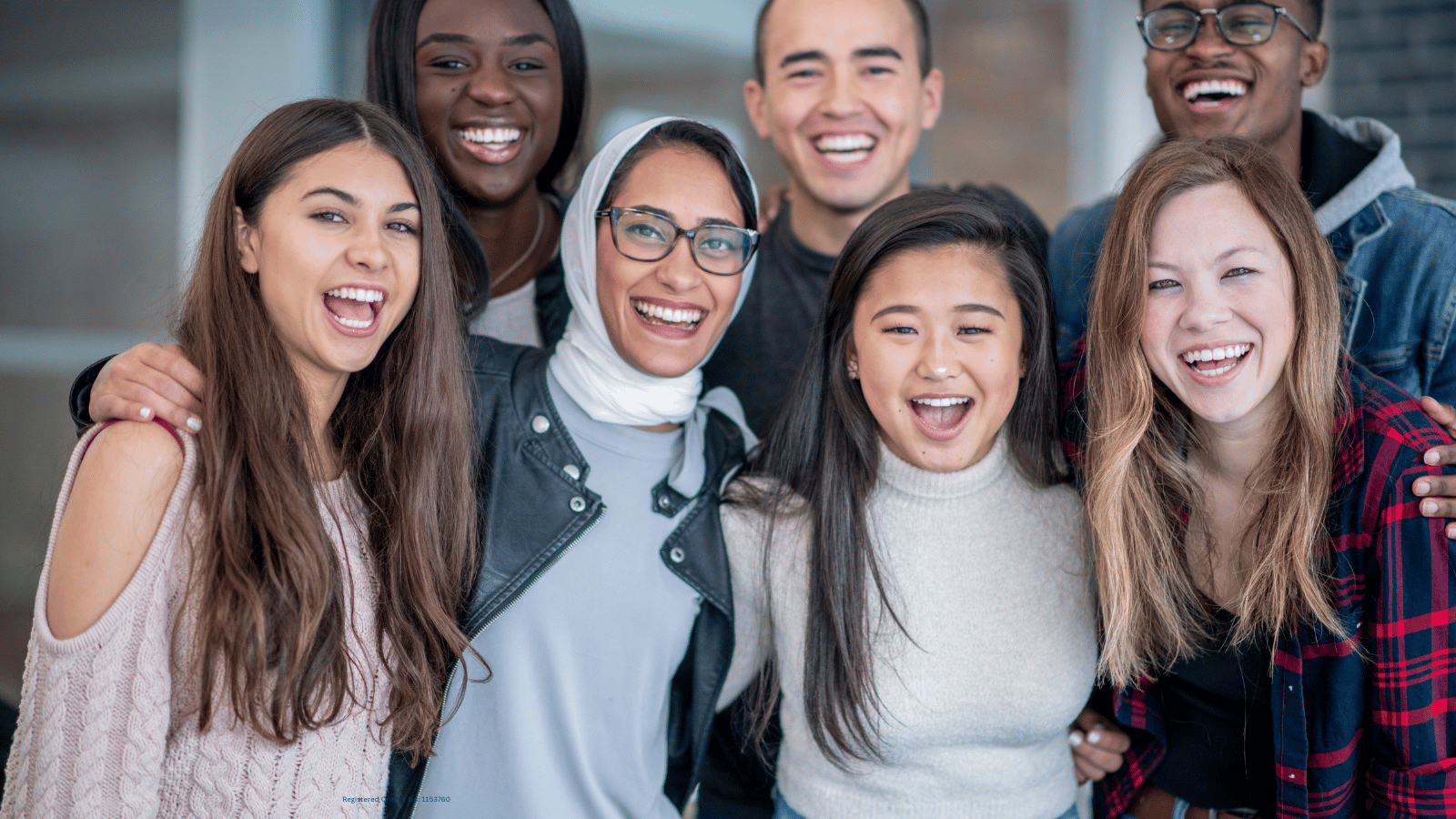 A group of young people smiling and posing for a photo